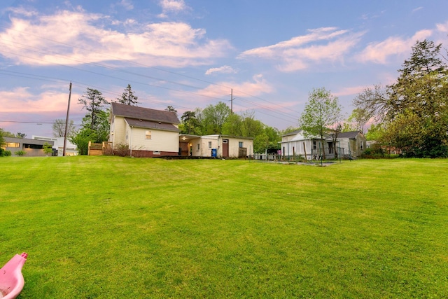 692 Millsboro Rd, Mansfield, OH 44903 - yard at dusk featuring a lawn