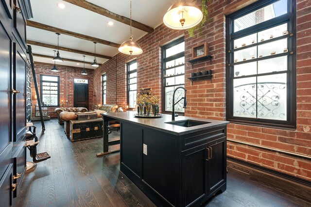 43-45 W Markison Ave, Columbus, OH 43207 - kitchen featuring brick wall, a sink, dark cabinets, dark wood finished floors, and plenty of natural light