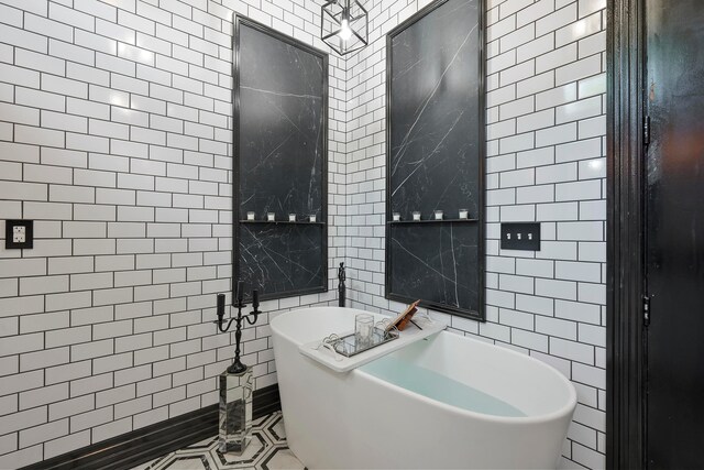 43-45 W Markison Ave, Columbus, OH 43207 - bathroom with tile walls, a freestanding tub, and tile patterned flooring