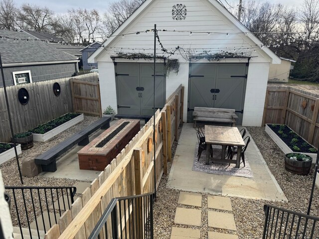 43-45 W Markison Ave, Columbus, OH 43207 - view of patio / terrace with a vegetable garden, a fenced backyard, and an outdoor structure