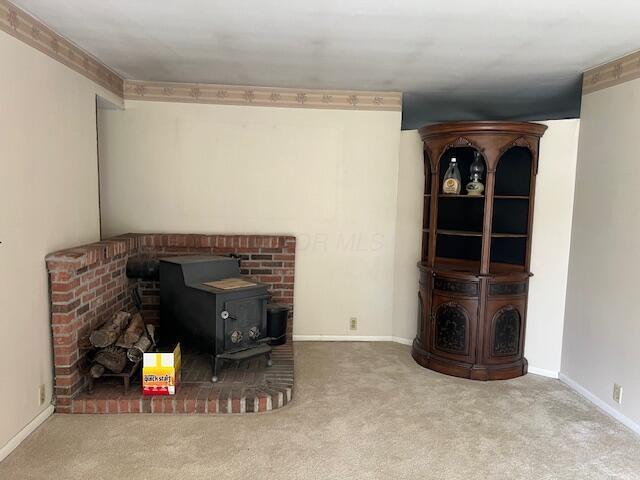 1886 Johnstown Utica Rd NE, Utica, OH 43080 - living room with a wood stove, carpet flooring, and baseboards