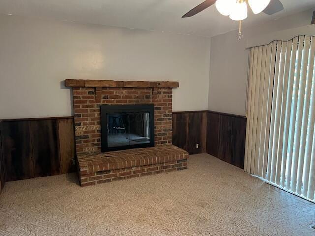 1886 Johnstown Utica Rd NE, Utica, OH 43080 - carpeted living room featuring a ceiling fan, wainscoting, wooden walls, and a fireplace