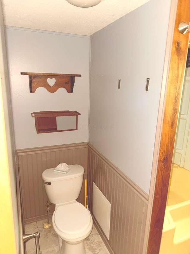 2785 Eckert Rd, Lexington, OH 44904 - bathroom featuring a wainscoted wall, toilet, and marble finish floors