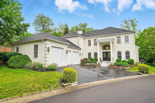 1940 Scioto Pointe Dr, Columbus, OH 43221 - neoclassical home featuring a garage, asphalt driveway, stucco siding, and a front lawn