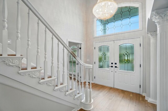 1940 Scioto Pointe Dr, Columbus, OH 43221 - entryway with stairs, a chandelier, wood-type flooring, a high ceiling, and baseboards