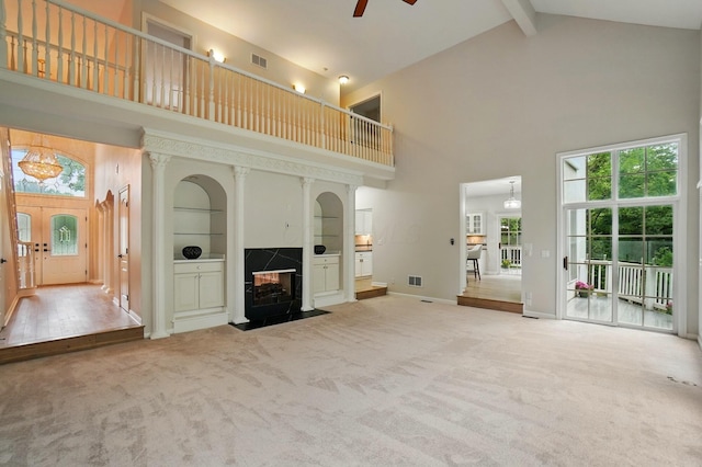 1940 Scioto Pointe Dr, Columbus, OH 43221 - unfurnished living room with high vaulted ceiling, carpet, a premium fireplace, ceiling fan, and beamed ceiling