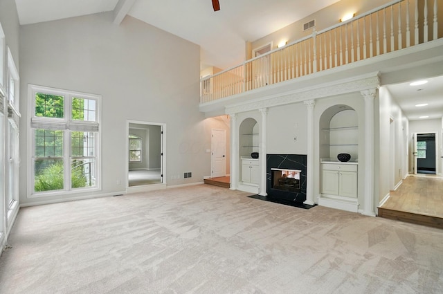 1940 Scioto Pointe Dr, Columbus, OH 43221 - unfurnished living room with high vaulted ceiling, a fireplace, carpet, beamed ceiling, and built in features