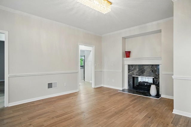 1940 Scioto Pointe Dr, Columbus, OH 43221 - unfurnished living room featuring wood finished floors, crown molding, baseboards, a premium fireplace, and a chandelier