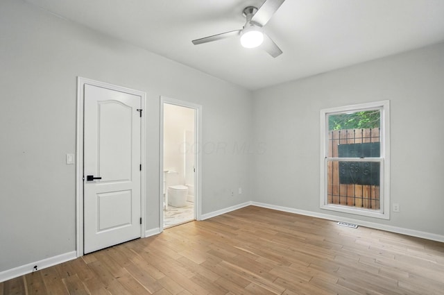 1940 Scioto Pointe Dr, Columbus, OH 43221 - unfurnished bedroom featuring wood finished floors, baseboards, connected bathroom, and a ceiling fan