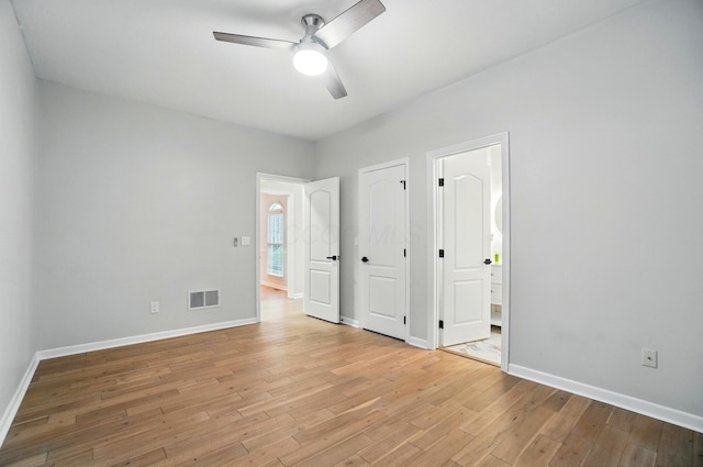 1940 Scioto Pointe Dr, Columbus, OH 43221 - unfurnished bedroom featuring light wood-style flooring, baseboards, ensuite bathroom, and ceiling fan