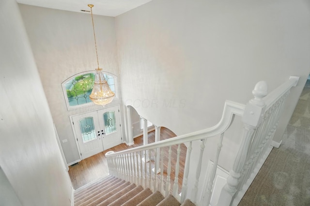 1940 Scioto Pointe Dr, Columbus, OH 43221 - entryway with stairs, a chandelier, french doors, wood finished floors, and arched walkways
