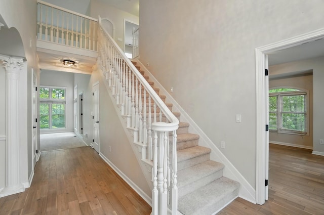1940 Scioto Pointe Dr, Columbus, OH 43221 - stairway with hardwood / wood-style floors, healthy amount of natural light, baseboards, and ornate columns