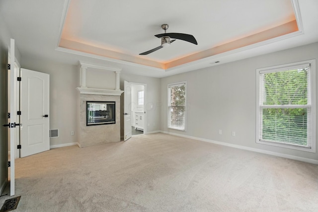1940 Scioto Pointe Dr, Columbus, OH 43221 - unfurnished living room with a tray ceiling, carpet flooring, ceiling fan, and baseboards