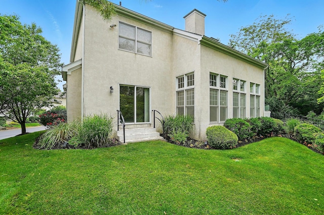 1940 Scioto Pointe Dr, Columbus, OH 43221 - back of house featuring stucco siding, a chimney, and entry steps