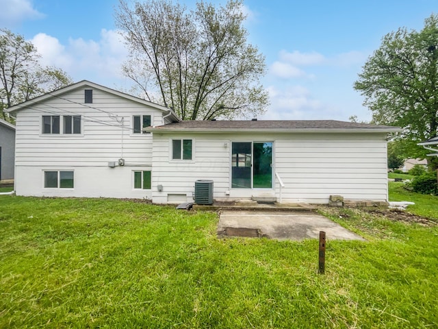 back of house featuring a patio, a yard, and central AC