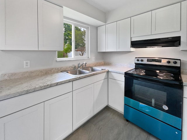 kitchen featuring range with electric stovetop, under cabinet range hood, a sink, white cabinetry, and light countertops
