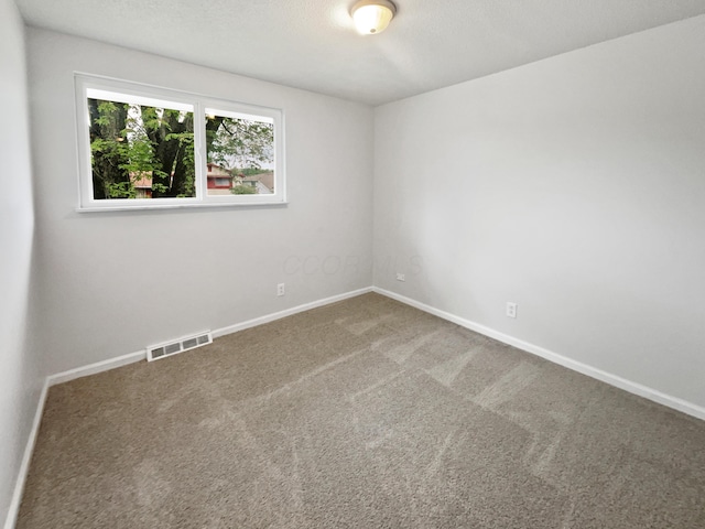 unfurnished room with carpet floors and baseboards