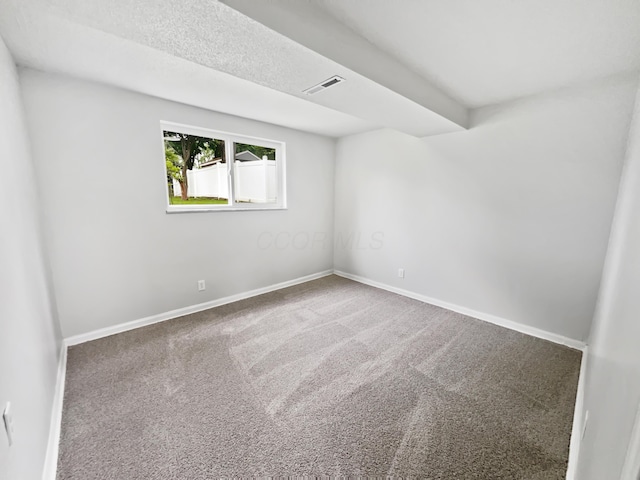 carpeted empty room with baseboards