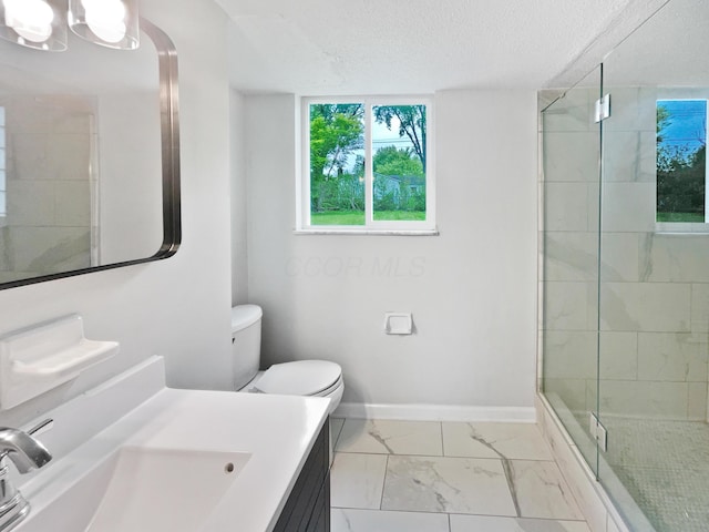 full bathroom featuring a shower stall, marble look tile flooring, baseboards, vanity, and toilet