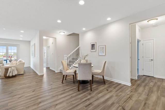 6039 Peck Ln, New Albany, OH 43054 - dining area featuring light wood-style floors, recessed lighting, stairway, and baseboards