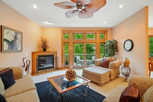1092 George Allen Dr, South Vienna, OH 45369 - living area with carpet, a glass covered fireplace, a ceiling fan, and recessed lighting