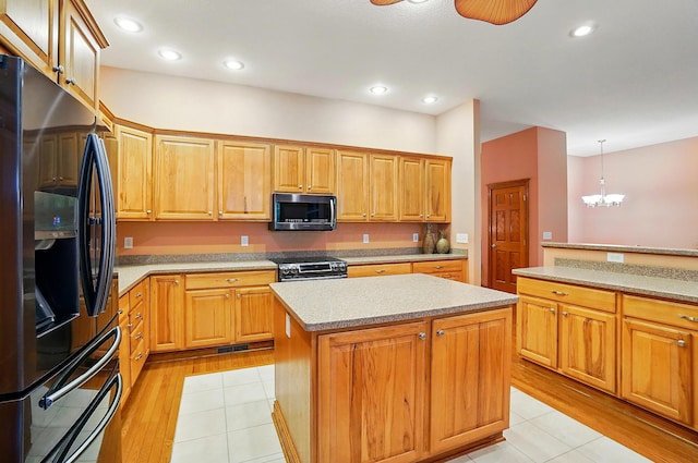 1092 George Allen Dr, South Vienna, OH 45369 - kitchen featuring appliances with stainless steel finishes, a center island, light countertops, light wood-style floors, and recessed lighting