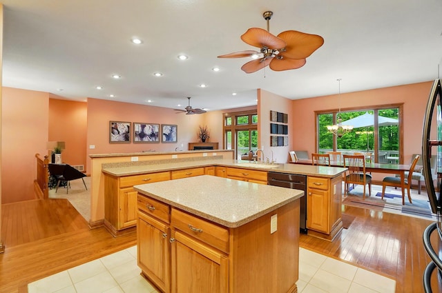 1092 George Allen Dr, South Vienna, OH 45369 - kitchen featuring a kitchen island, dishwashing machine, ceiling fan, a sink, and light tile patterned floors