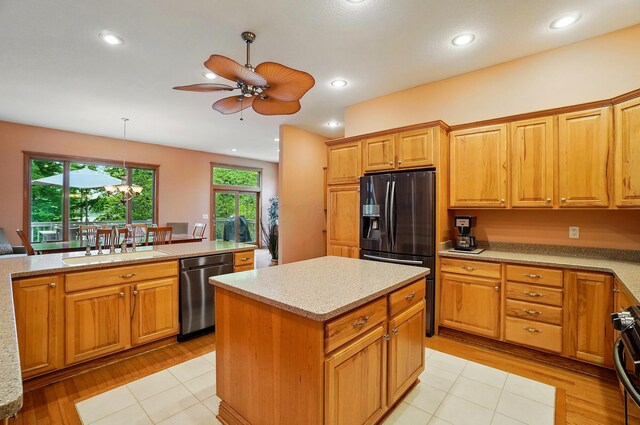 1092 George Allen Dr, South Vienna, OH 45369 - kitchen featuring stainless steel dishwasher, black fridge with ice dispenser, ceiling fan, a sink, and light wood finished floors