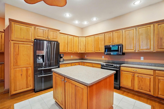 1092 George Allen Dr, South Vienna, OH 45369 - kitchen featuring appliances with stainless steel finishes, light tile patterned flooring, a center island, recessed lighting, and light countertops