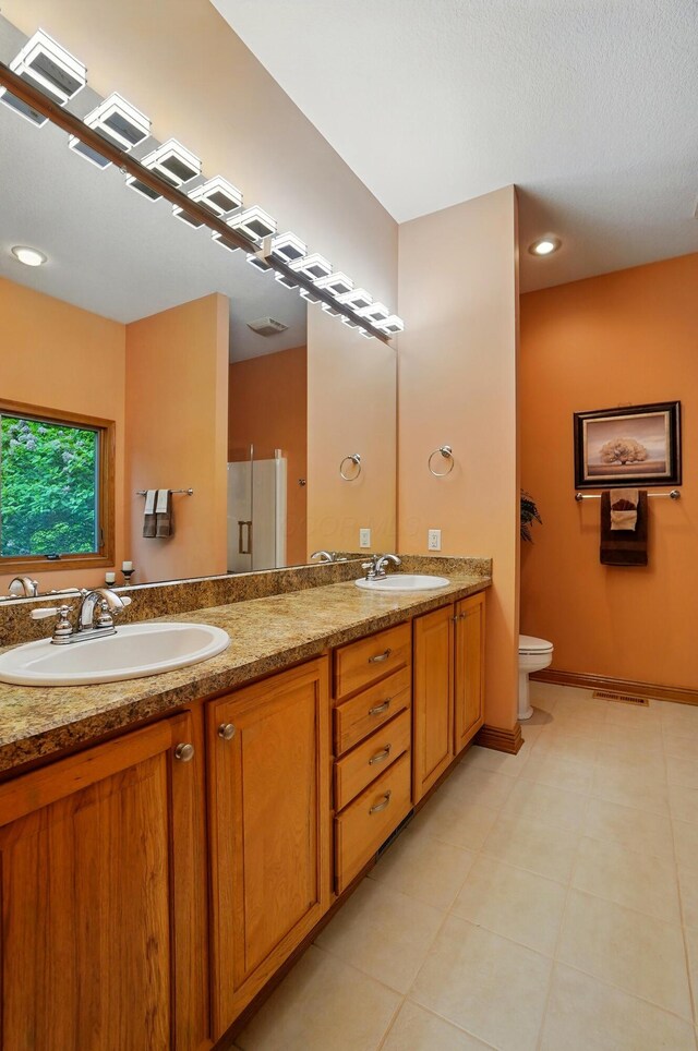 1092 George Allen Dr, South Vienna, OH 45369 - full bath featuring double vanity, toilet, baseboards, and a shower