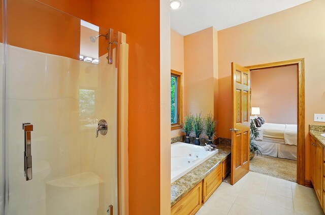 1092 George Allen Dr, South Vienna, OH 45369 - bathroom with a stall shower, tile patterned floors, a jetted tub, connected bathroom, and vanity