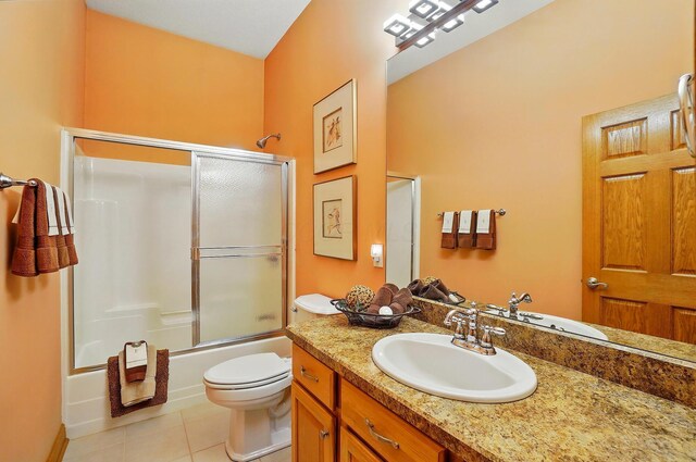 1092 George Allen Dr, South Vienna, OH 45369 - bathroom with tile patterned floors, bath / shower combo with glass door, toilet, and vanity