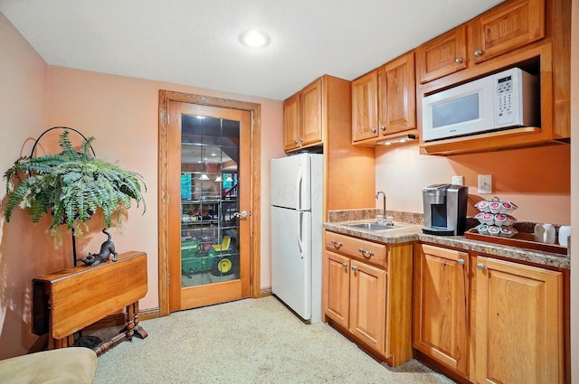 1092 George Allen Dr, South Vienna, OH 45369 - kitchen featuring white appliances, a sink, and brown cabinets