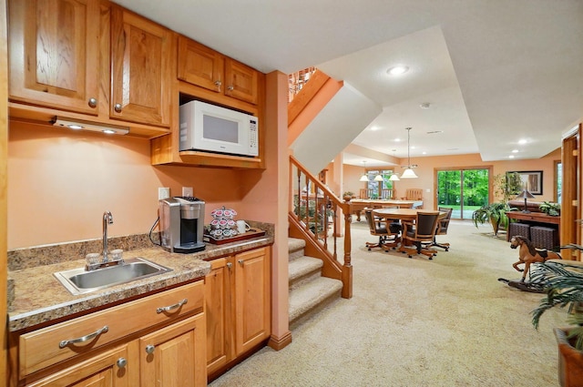 1092 George Allen Dr, South Vienna, OH 45369 - kitchen with white microwave, a sink, light colored carpet, recessed lighting, and light countertops