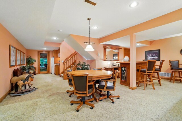 1092 George Allen Dr, South Vienna, OH 45369 - dining space with carpet floors, stairs, bar area, baseboards, and recessed lighting
