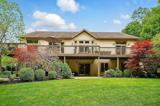 1092 George Allen Dr, South Vienna, OH 45369 - rear view of house with stucco siding, a wooden deck, and a yard
