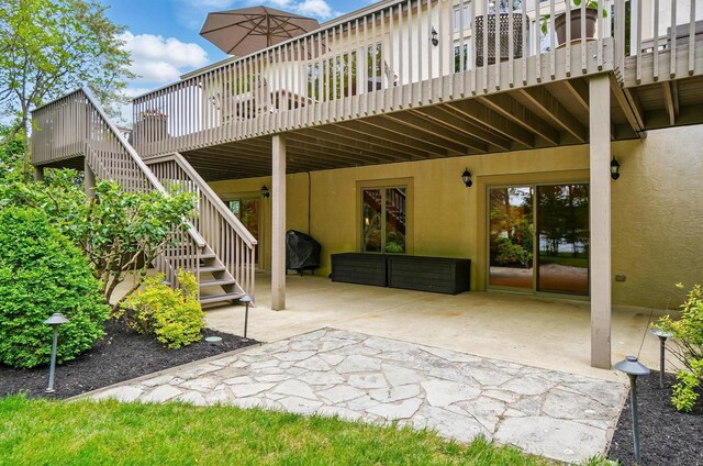 1092 George Allen Dr, South Vienna, OH 45369 - rear view of house with stucco siding, a patio area, stairs, and a wooden deck