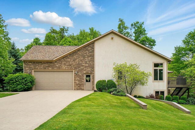 1092 George Allen Dr, South Vienna, OH 45369 - view of front facade featuring driveway, a garage, brick siding, and a front lawn