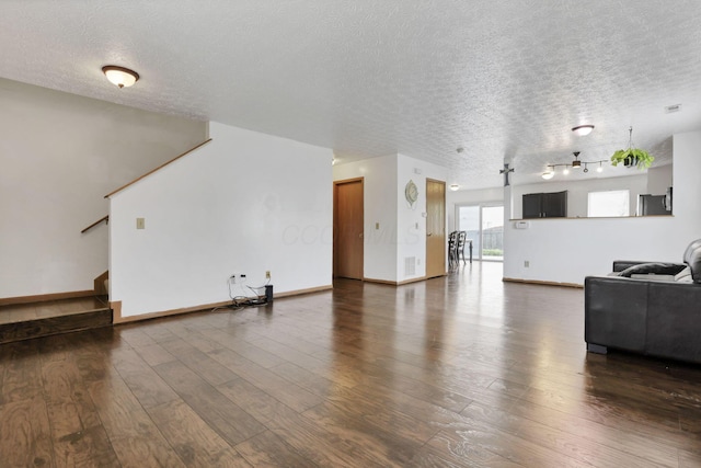 5504 Rothermund Dr, Canal Winchester, OH 43110 - living room with a textured ceiling, dark wood-style floors, stairway, and baseboards