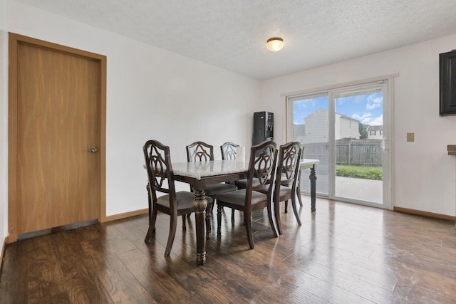 5504 Rothermund Dr, Canal Winchester, OH 43110 - dining space featuring dark wood-style flooring, baseboards, and a textured ceiling