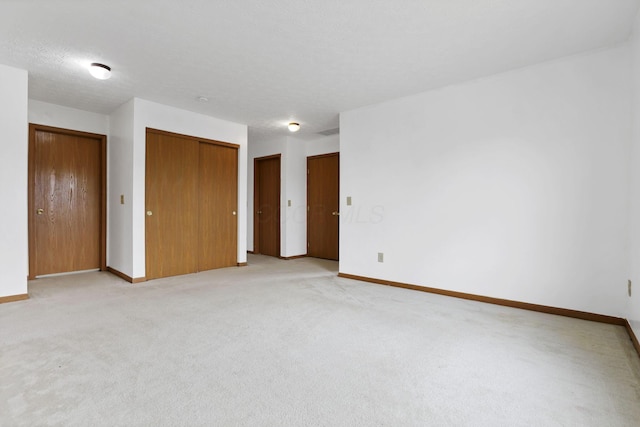 5504 Rothermund Dr, Canal Winchester, OH 43110 - unfurnished bedroom with baseboards, multiple closets, and light carpet
