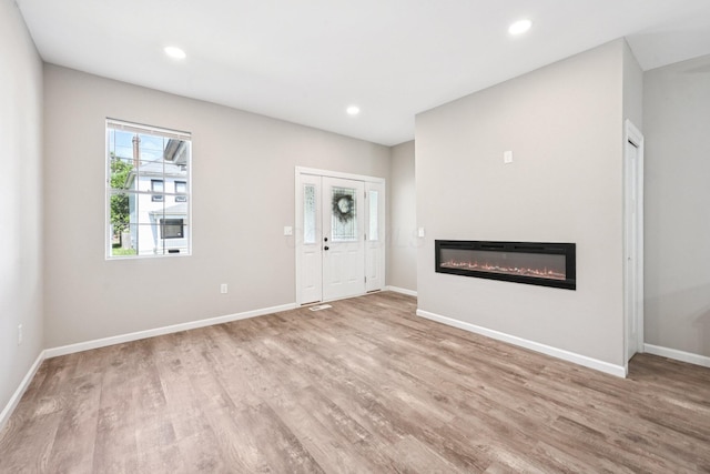 434 S Champion Ave, Columbus, OH 43205 - unfurnished living room featuring a glass covered fireplace, wood finished floors, and recessed lighting