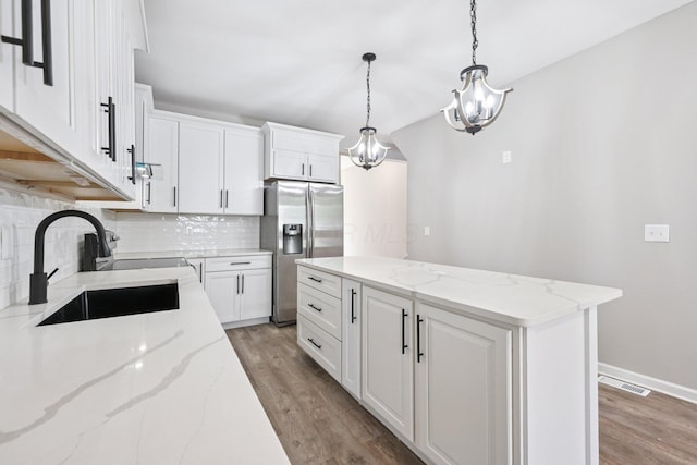 434 S Champion Ave, Columbus, OH 43205 - kitchen with stainless steel refrigerator with ice dispenser, tasteful backsplash, a center island, and light wood finished floors