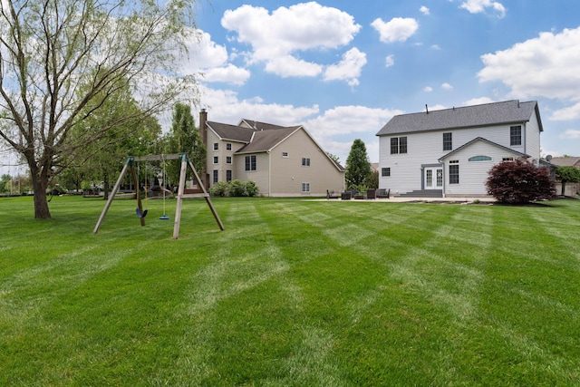 4526 Hoffman Farms Dr, Hilliard, OH 43026 - rear view of house with a playground, a patio area, a lawn, and a chimney