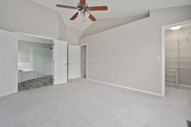 4526 Hoffman Farms Dr, Hilliard, OH 43026 - unfurnished bedroom featuring carpet floors, a walk in closet, lofted ceiling, a closet, and baseboards