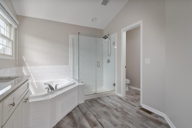 4526 Hoffman Farms Dr, Hilliard, OH 43026 - bathroom with a shower stall, a bath, wood finished floors, toilet, and lofted ceiling