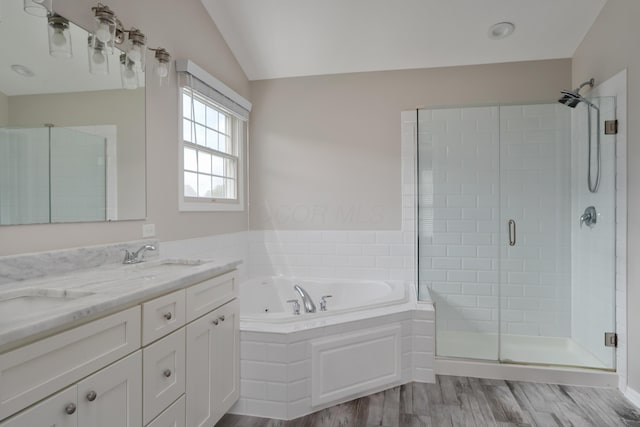4526 Hoffman Farms Dr, Hilliard, OH 43026 - full bathroom featuring a shower stall, a bath, double vanity, wood finished floors, and vaulted ceiling