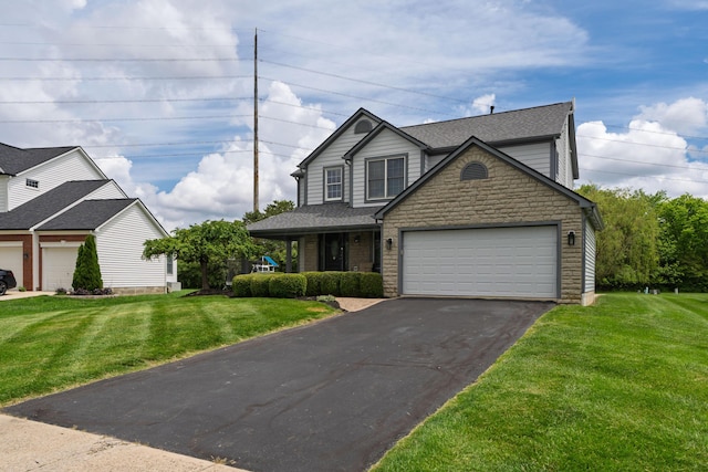 4526 Hoffman Farms Dr, Hilliard, OH 43026 - traditional-style house featuring driveway, a front lawn, stone siding, and a garage