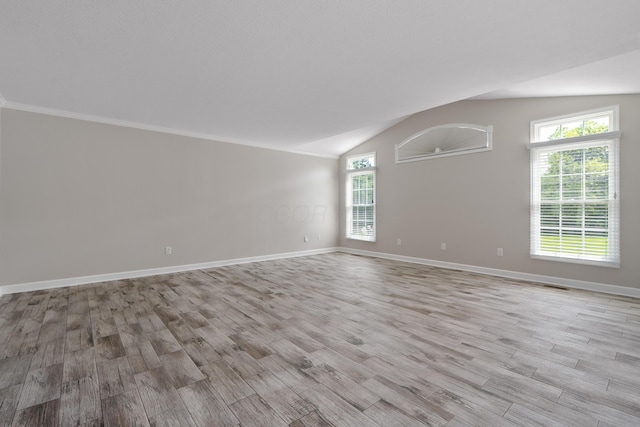 4526 Hoffman Farms Dr, Hilliard, OH 43026 - empty room featuring light wood-type flooring, baseboards, and lofted ceiling