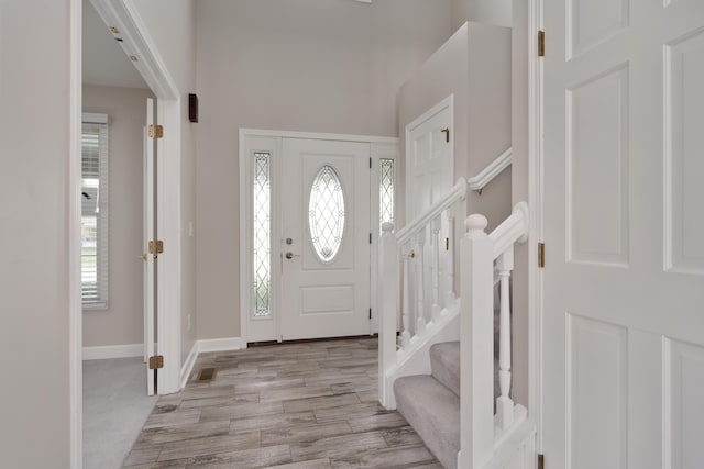 4526 Hoffman Farms Dr, Hilliard, OH 43026 - entryway featuring a high ceiling, light wood-style flooring, and baseboards
